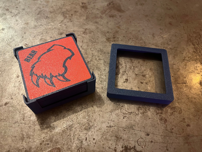 Red and black box with bear design on a textured surface