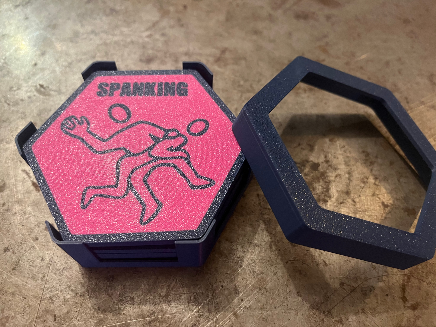 Pink and black object with a graphic design on a textured surface