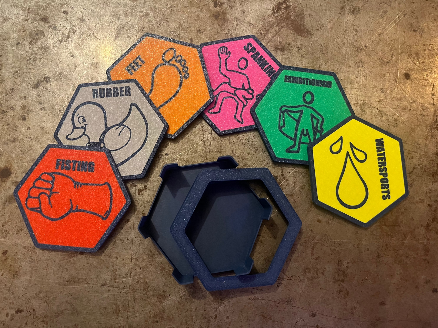 Hexagonal stickers with various designs on a textured surface