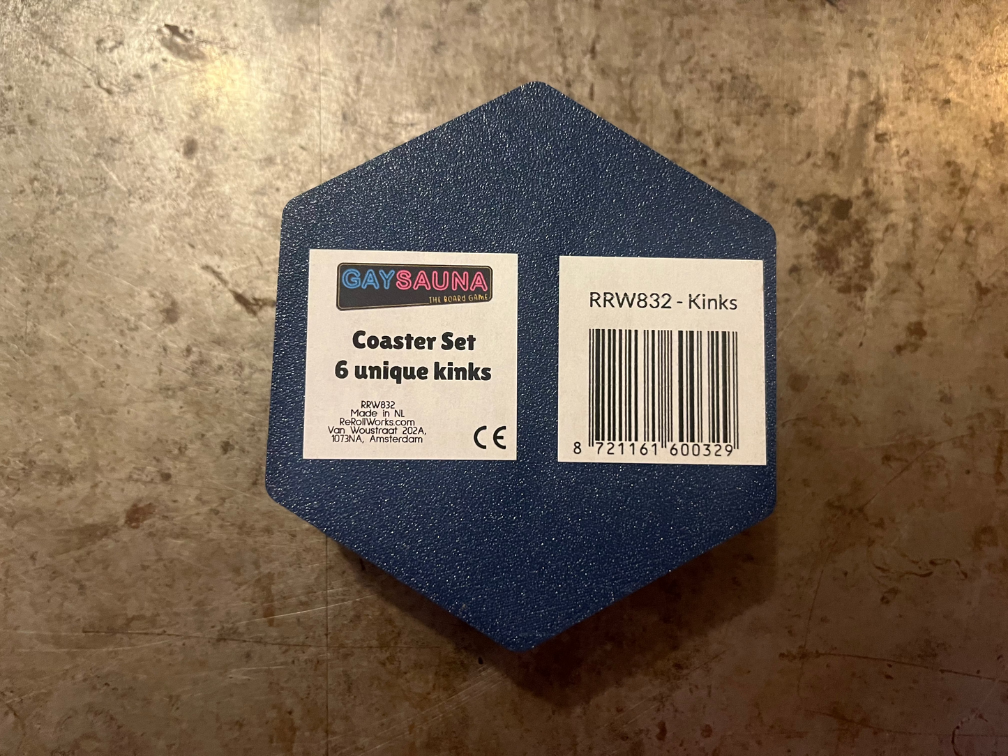 Hexagonal blue coaster set with labels on a textured surface