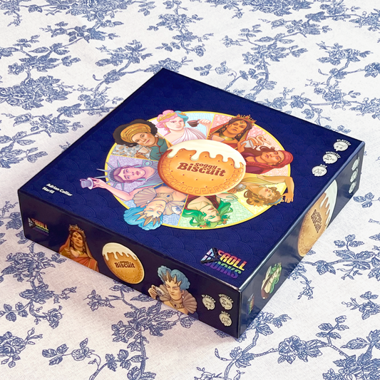 Soggy Biscuit Hidden Role Card Game Box on a floral tablecloth